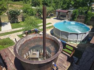 a hot tub and a swimming pool next to a hot tub at Rooms Poienita in Slănic-Moldova