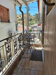 a balcony with a table and chairs on it at Aegean escape in Mytilini in Mytilene