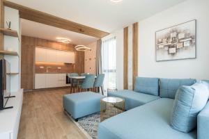 a living room with a blue couch and a table at Luxury Ap Blanka - Pool & Panorama in Azur in St. St. Constantine and Helena +19 photos
