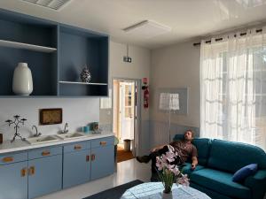 a woman sitting on a couch in a living room at Domaine familial du château de Ragny in Savigny-en-Terre-Plaine