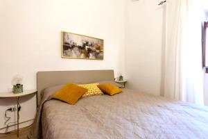 ノートにあるCasa Vico Ferruccio 24のベッドルーム1室(黄色い枕のベッド1台付)