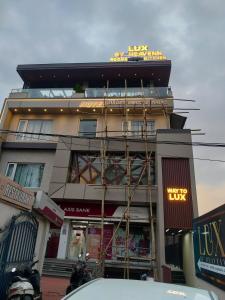 a building with a sign on the top of it at Hotel LUX by Heavenn in Dehradun