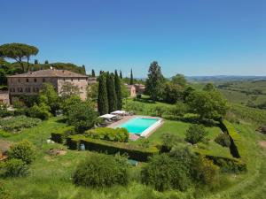 an aerial view of a house with a swimming pool at Tenuta di Corsano in Monteroni dʼArbia