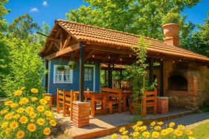 a small blue house with a table and a fireplace at Dream House in Batumi