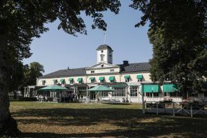 a large white building with a clock tower at Söderköpings Brunn in Söderköping
