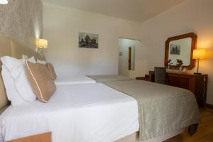 Postel nebo postele na pokoji v ubytování Hotel Sao Jorge Garden