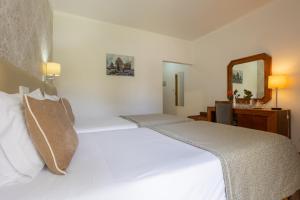 Postel nebo postele na pokoji v ubytování Hotel Sao Jorge Garden