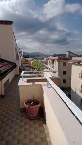 a balcony with a potted plant on a roof at Appartamento Napodano in Tortora +8 photos
