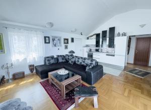 a living room with a black couch and a table at Luxury Beachfront Apartments Matista in Trogir