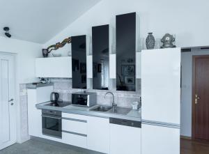 a white kitchen with a sink and a refrigerator at Luxury Beachfront Apartments Matista in Trogir