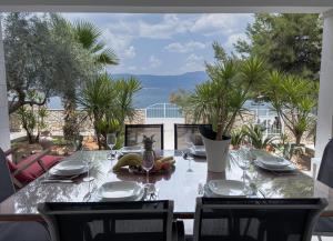 a dining room table with a view of the ocean at Luxury Beachfront Apartments Matista in Trogir
