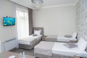 Postel nebo postele na pokoji v ubytování Max Hotel