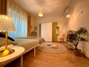 a bedroom with a bed and a table with a lamp at Twin Homes - Tamerò Estates in Poggio Mirteto