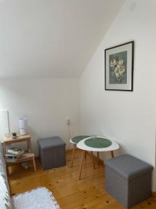 a living room with a table and a chair at Ivaa in Nova Varoš