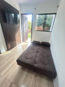 a bedroom with a large bed in a room at Micro casa Maju in Cascavel