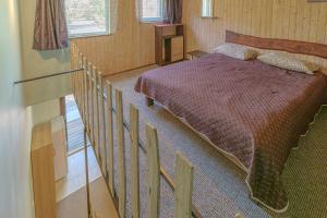 a bedroom with a bed next to a staircase at 11 kopų in Šventoji