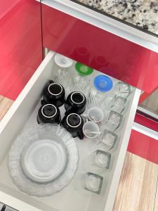 a drawer in a kitchen with plates and dishes at Micro casa Maju in Cascavel