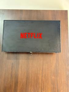 a sign that says netflix on a wooden wall at Micro casa Maju in Cascavel