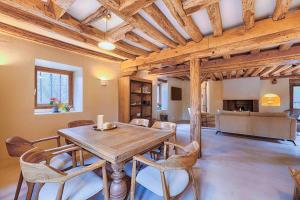 a dining room with a wooden table and chairs at Le Moulin de Rochopt in Boussy-Saint-Antoine +53 photos