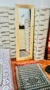 a mirror in the corner of a room with a rug at a studio apartment in Taghazout +3 photos