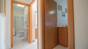 a bathroom with a door open to a bathroom with a toilet at Domus Peppi in Villasimius +16 photos