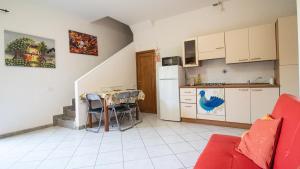 a kitchen with a table and a kitchen with a refrigerator at Domus Peppi in Villasimius