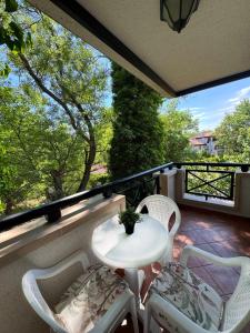 a patio with a table and chairs on a balcony at Casa Oasis Lozenets in Lozenets