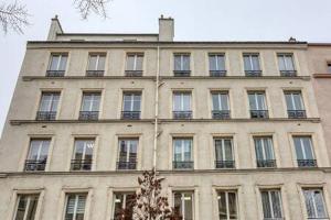 a large building with many windows on top of it at Studio cosy proche Paris et du Bois de Vincennes in Charenton-le-Pont