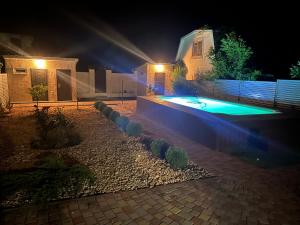 a backyard with a swimming pool at night at House in Karolino-Buhaz in Zatoka