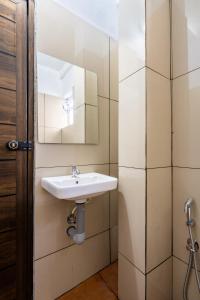 a bathroom with a sink and a mirror at Boat Residency in Cochin