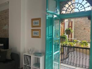a blue glass door in front of a window at My Symi Apartments in Symi