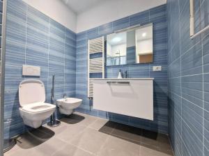 a bathroom with a toilet and a sink and a mirror at Amoenus in Atessa +31 photos