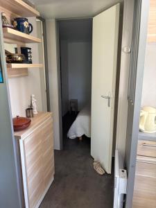 an open door to a room with a bedroom at Mobile-home dans un camping in Chorges