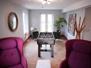 a living room with a table and two chairs at Spacious Cardiff Apartment for Large Groups! in Cardiff
