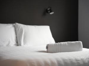 a white bed with white sheets and pillows at Spacious Cardiff Apartment for Large Groups! in Cardiff