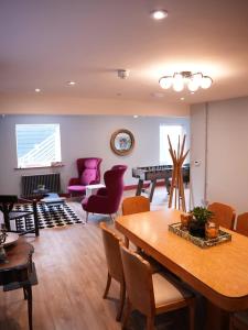 a living room with a table and chairs at Spacious Cardiff Apartment for Large Groups! in Cardiff