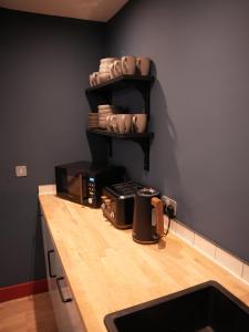 a kitchen with a counter top with a sink and a counter sidx sidx at Spacious Cardiff Apartment for Large Groups! in Cardiff