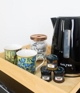 a wooden shelf with cups and a coffee maker on it at Lazy Acre Apartment - Heart of East Anglia in Hopton
