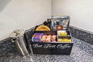 a box of first coffee sitting on a counter at Spacious Family Getaway- Salt Water Pool & Hot Tub in Lyndhurst