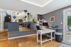 a kitchen with blue walls and a white table at Spacious Family Getaway- Salt Water Pool & Hot Tub in Lyndhurst