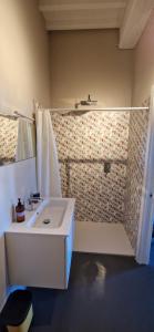 a bathroom with a white sink and a shower at Casal de' Matti - Casa Margot in Poggibonsi