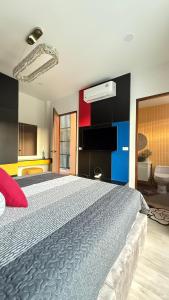 a bedroom with a large bed and a bathroom at De Flourishing Hill Pool Villa , Cha Am in Cha Am +53 photos