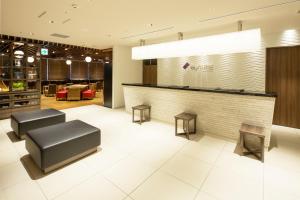 a lobby with a bar with two stools at MyCUBE by MYSTAYS Asakusa Kuramae in Tokyo