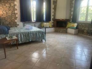 a room with a bed and a table and windows at Villa SUNSHINE in Sanfatucchio +2 photos