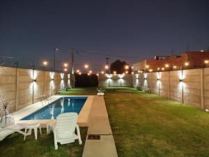 a backyard with a swimming pool at night at Quinta El sol in Reconquista