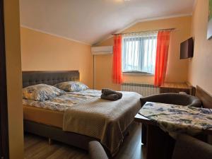 a bedroom with a bed with a stuffed animal on it at Apartamenty i pokoje z basenem AVENA Jastrzębia Góra in Jastrzębia Góra +31 photos
