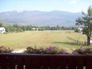 a view of a large field with mountains in the background at House Mara in Korenica
