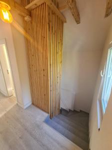 a staircase in a room with a wooden wall at Villa M&E Oasis with Private Pool in Košelji +26 photos