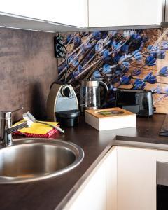 a kitchen with a sink and a counter top at Home of heart Schladming in Schladming