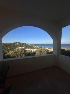a room with two windows with a view of the ocean at Karfas Endless Blue Studio in Karfas
